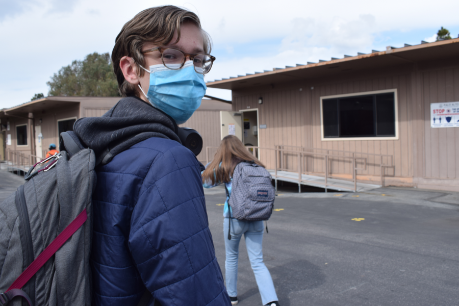 Connor Lassila (sophomore) walks to his next class outside the science
building while wearing a mask. Paly requires all students to wear a mask
while on campus.
Photo: Anya Lassila.