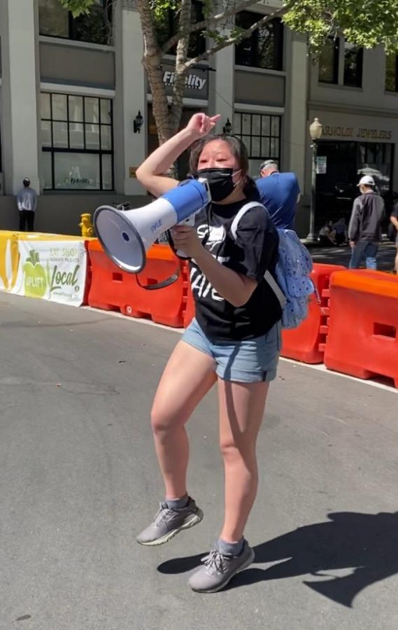 STOP ASIAN HATE. Megaphone in hand, Johannah Seah, speaks with passion to her fellow protesters while marching towards Palo Alto City Hall during the “8 by 8 Stop Asian Hate” rally on May 2. Photo by Michaela Seah.