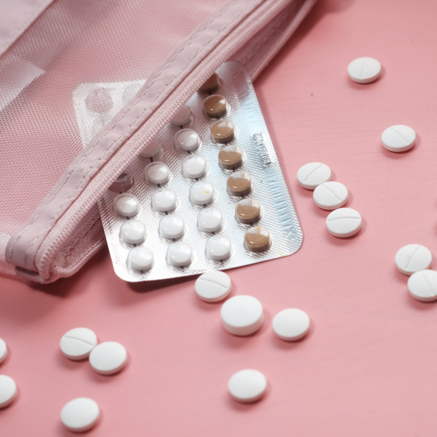 Birth control pills spill out onto a countertop.