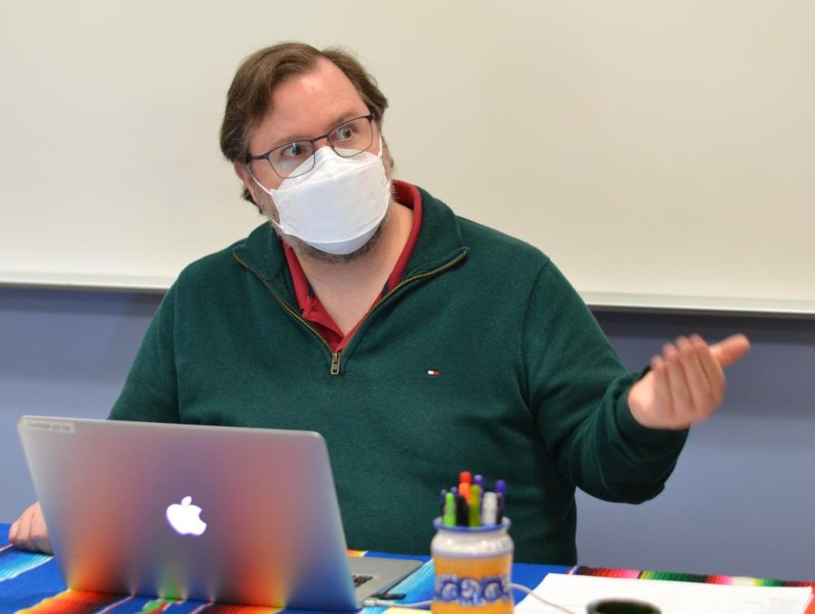 Spanish teacher Kevin Duffy sits at his desk during an interview Wednesday with journalism students. Our place is here with our students and it was so hard when we were on Zoom learning, Duffy said. Photo: Anushe Irani.