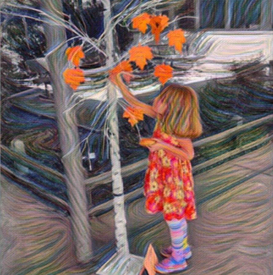 A Duveneck Elementary School student adds her leaf to the Unity Tree, which is a Unity Day activity led by Paly Child Development students.
