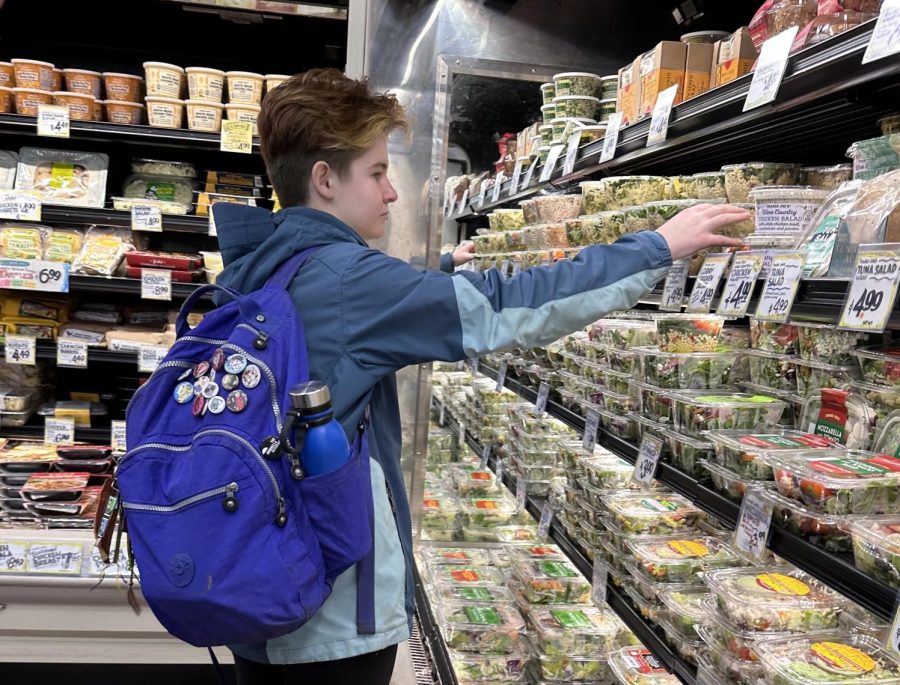 Palo Alto High School senior Eliza Mutz picks up lunch from the sandwich and salad section at Trader Joes.
Trader Joes prices, as with most prices at Town and Country, have increased as inflation has risen. “I think [the prices]
used to be a lot cheaper,” Mutz said.