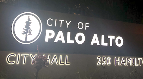 Photo of Palo Alto City Hall at night with blue and yellow lights lighten up. (Photo by Lara Dumanli)