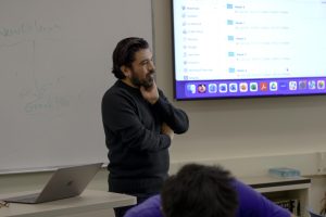 New english department instructional leader, Richard Rodriguez waits patiently for students to answer his request in the classroom. 