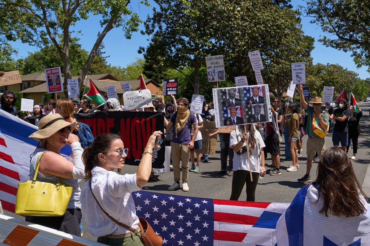 Protesters gather at the intersection of Addison Avenue and Middle Field Road demanding action from President Biden regarding the Israel-Hamas war. 