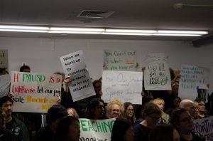 PROTESTING FOR PAY. Hundreds of PAUSD staff and Palo Alto community members gather at a school board meeting on April 29th to speak out amidst an impasse in negotiations between staff members and the district. 