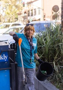 Athena, a Downtown Streets Team member, cleans up the streets of Palo Alto as part of DST's community beautification initiative. Athena has gained a renewed sense of purpose, contributing to her community and finding stability after facing significant personal challenges. "It just gave me something to focus my effort on. They’re helping me with housing too, because I was in a place where there was a lot of drug use. I didn’t want to be around it,” Athena shared.
