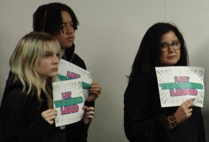 Staff and teachers holding up signs that read “Let Teachers Lead” in support of the Ethnic Studies class at a PAUSD board meeting on Jan 21. 