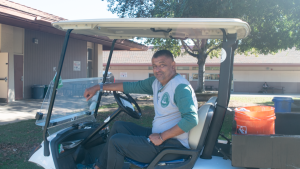 Late Palo Alto High School Campus Supervisor Ernesto Cruz sits in his golf cart.