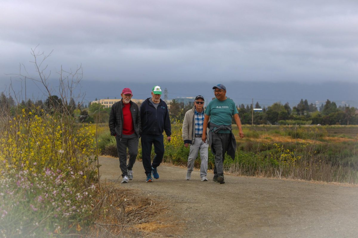 Members of the BayArea FrontRunners walk together as they reminisce about their week. Many of them have been friends for over 10 years.