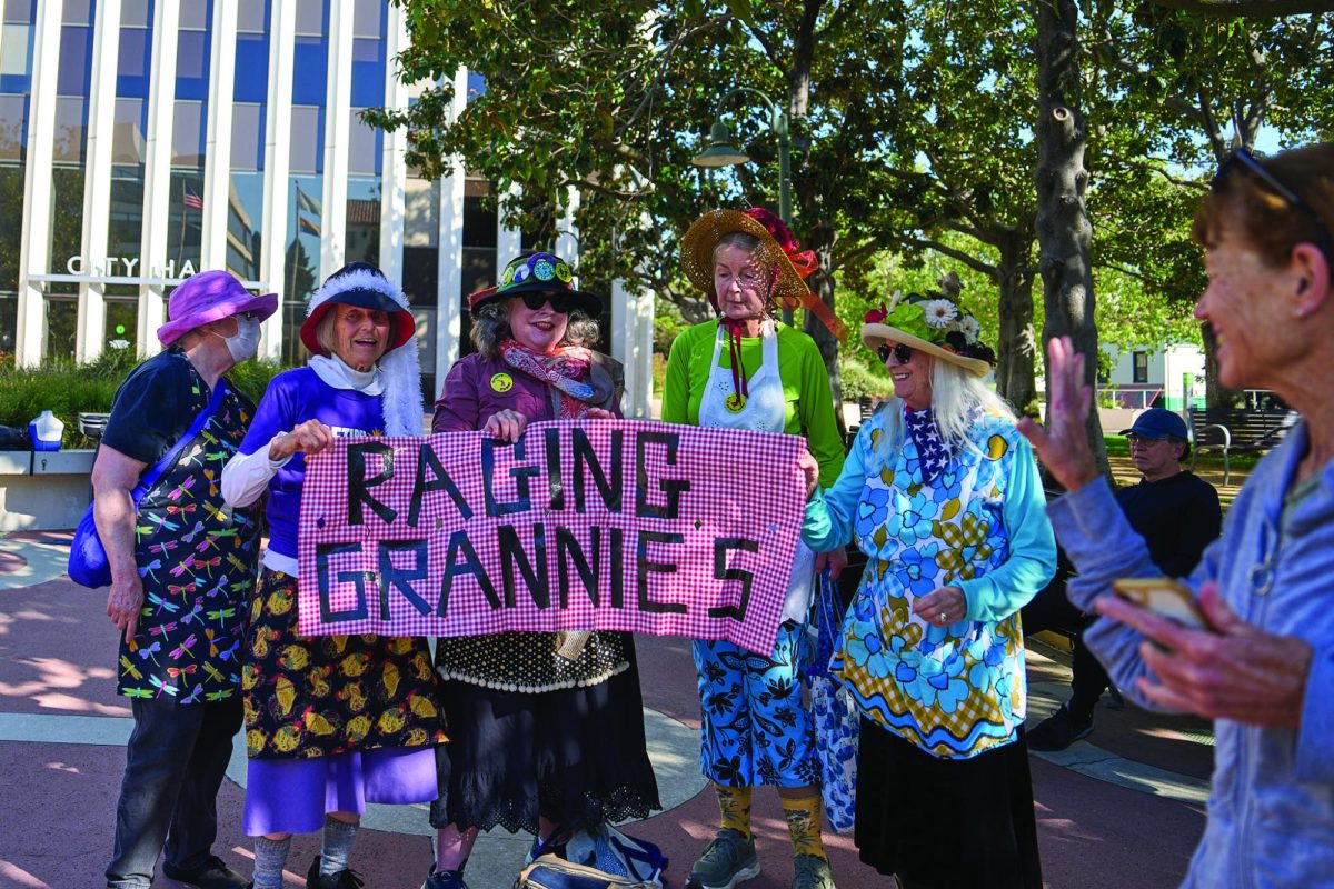 The Palo Alto chapter of the Raging Grannies stands in front of the Palo Alto City Hall advocating for action against polluters in the city during the annual Earth Day protest on April 18.