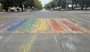 CHALKING CHANGE. A rainbow chalked crosswalk sits across from Paly’s Churchill entrance. One Palo Alto resident who participated in the chalking said it was done to support LGBTQ+ students. “This just felt like a happy thing that we could do that could hopefully bring a smile to some students faces,” the participant said. Photo: Anonymous