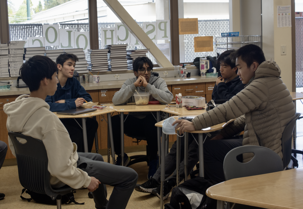 Palo Alto High School’s Eco Club co-presidents Aiden Miao (left) and Agastya Parikh (center) meet with club members on Jan. 20. The club is planning a climate exposition to raise awareness for climate conservation efforts on Earth Day. “We are inviting organizations, including Paly clubs, to host tables at the Quad,” Parikh said.