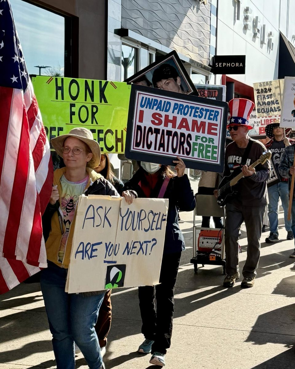 Wolves on the March: Members of The Wolves demonstrate outside the Stanford Shopping Center during one of the group’s weekly Saturday protests, with signs ranging from calls for free speech to shaming dictators. “If we have an idea for something we want to do, we can make it happen the next day.” Scott Herscher said. 